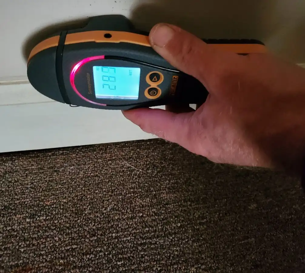 Moisture detection at baseboard during Storm Damage Restoration in Lennox